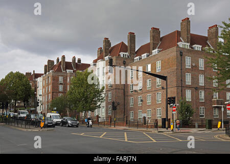 Local Authority 1930s tenement blocks on Dog Kennel Hill in South London. Large, traffic light controlled junction in foreground Stock Photo