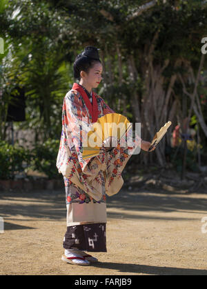 Okinawan woman in traditional costume performing fan dance, Ryukyu Mura, Okinawa, Japan Stock Photo