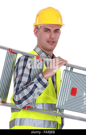 Laborer carrying ladder Stock Photo