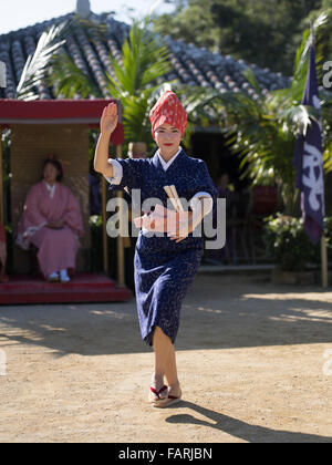 Okinawan woman in traditional costume perform folk dance, Ryukyu Mura, Okinawa, Japan Stock Photo