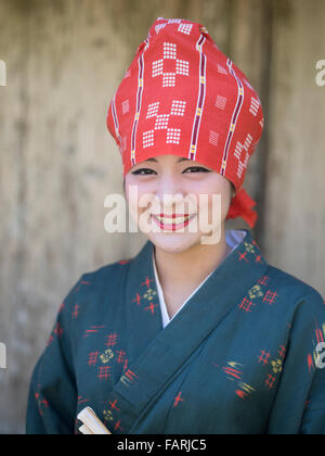 Okinawan woman in traditional costume, Ryukyu Mura, Okinawa, Japan Stock Photo