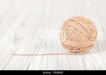 Wool ball on a white wooden background. Stock Photo