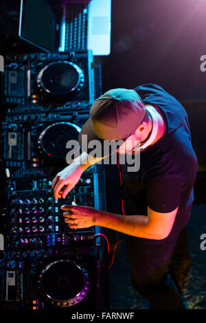 DJ man mixing electronic music on stage. Shot from aerial view Stock Photo