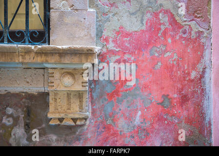 Wall Italy old, detail of a faded and weathered patch of red stucco on a wall in the historic old town of Ortigia, Syracuse, Sicily. Stock Photo