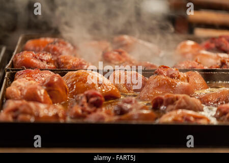 Meat is fried on a big frying pan at street fair Stock Photo