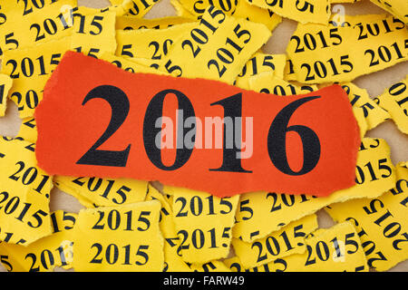 Torn piece of red paper with year 2016 on torn pieces background with year 2015. Stock Photo