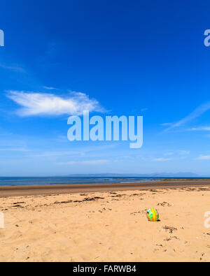 Child's plastic football left on the beach at Croy Shore, South Ayrshire, Scotland, UK  Model Release: No.  Property Release: No. Stock Photo