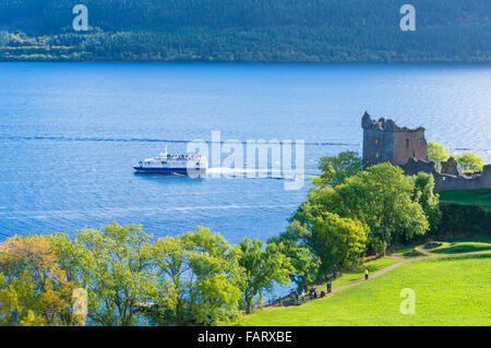 Loch Ness Cruise boat passing close to Urquhart Castle next to Loch Ness on Strone Point Highlands of Scotland UK GB EU Europe Stock Photo