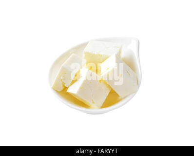 bowl of feta cheese cubes on white background Stock Photo