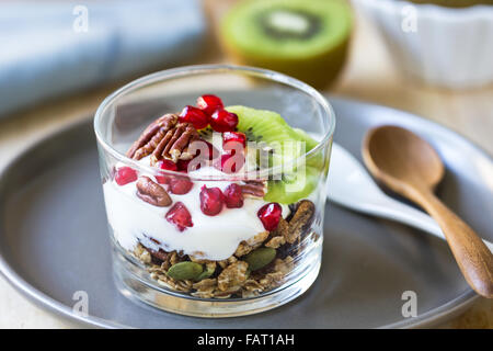 Granola with Greek yogurt ,Kiwi and Pomegranate in a glass Stock Photo