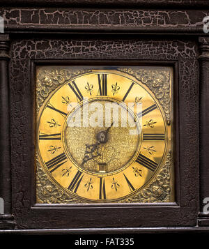 Antique grandfather clock face detail with distressed wooden casing. Stock Photo