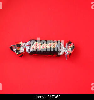 Mars fun size bar left in the bottom of a tub of chocolates. Stock Photo