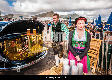 The Goodwood Revival festival held each September at Goodwood Circuit for classic cars and costumes. Female in dirndl traditional German attire Stock Photo