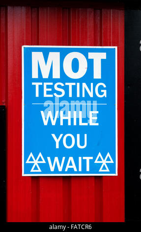 MOT While U Wait Sign Stock Photo - Alamy