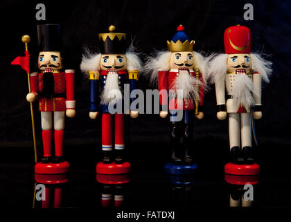 Colorful collection of wooden Christmas nutcrackers on a black background Stock Photo