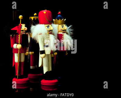 Colorful collection of wooden Christmas nutcrackers on a black background Stock Photo