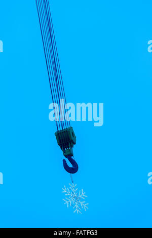 Crane hook with snowflake decoration. Stock Photo