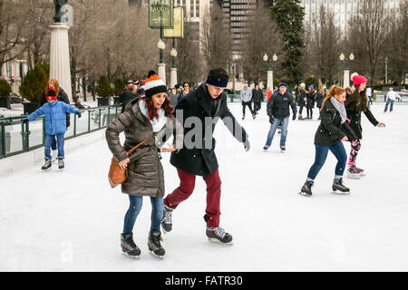 Chicago, USA 4th January 2016. Skaters at Millennium Park weather a lake effect snow shower blowing in from Lake Michigan. This young lady appears to have concerns other than the weather. After a relatively balmy December, 2016 started off on a colder note. Credit:  Todd Bannor/Alamy Live News Stock Photo