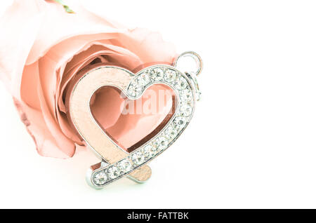 Diamond Heart shape pendant with pink rose on white background, vintage style. Stock Photo