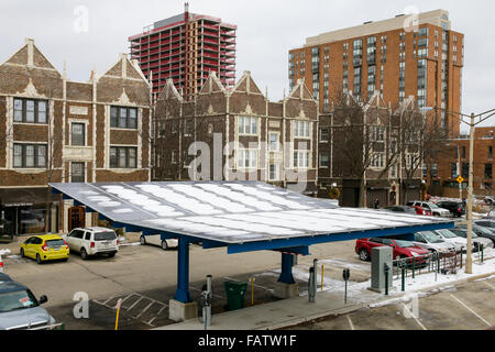 Snow covered solar panels at electric car charging station. Oak Park, Illinois. Stock Photo