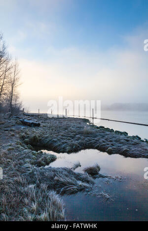 An early foggy morning on the banks of the Fraser River in Vancouver Stock Photo