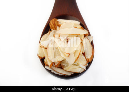 Sliced almonds in a wooden spoon Stock Photo