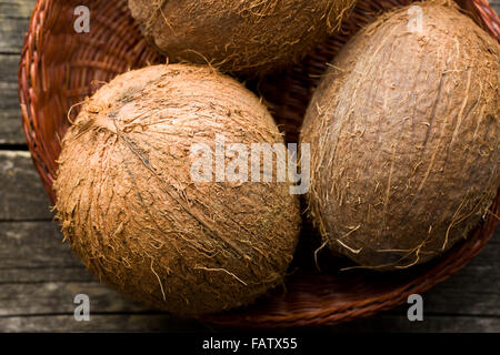 whole coconuts in a basket Stock Photo
