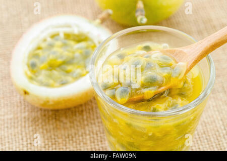 Passion fruit juice in glass and fresh passion fruit on sack background. Stock Photo