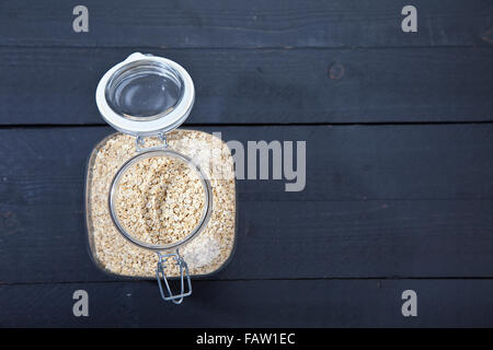 Oatmeal on dark wooden background Stock Photo