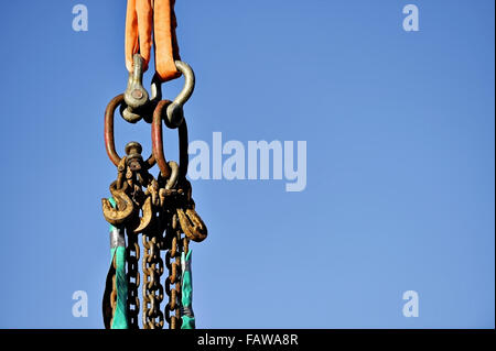 Heavy duty industrial chain hooked up on a construction crane Stock Photo