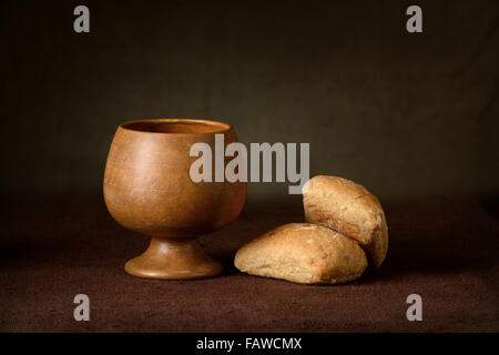 Communion elements with wine cup and bread on table Stock Photo