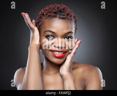 Black beauty with short spiky red hair Stock Photo