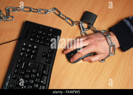 the man chained to the workplace, working at a computer Stock Photo