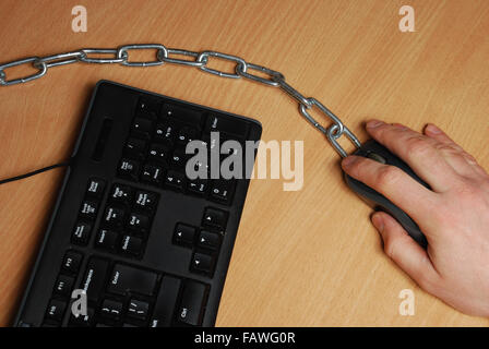 the man chained to the workplace, working at a computer Stock Photo