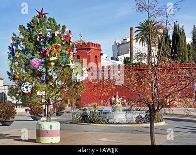 Moorish red castle walls in Plaza de la Constitucion Alhama de Granada ( 1482 the fortress town was taken from the Moorish Sultanate ) Spanish Spain Andalusia Stock Photo