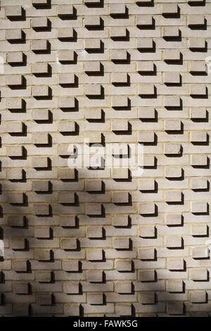 Brick wall with bricks extending beyond the wall, with shadows. Modern design feature, London, UK. Backgrounds and textures. Brick wall background. Stock Photo