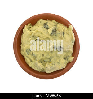 Top view of a portion of freshly made packaged spinach hommus in a small bowl isolated on a white background. Stock Photo