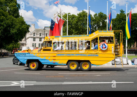 A London Duck Tours amphibious vehicle full of tourists in Parliament Square, London, England, UK Stock Photo