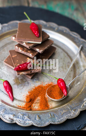 Spice red chilli peppers and chocolate, selective focus Stock Photo