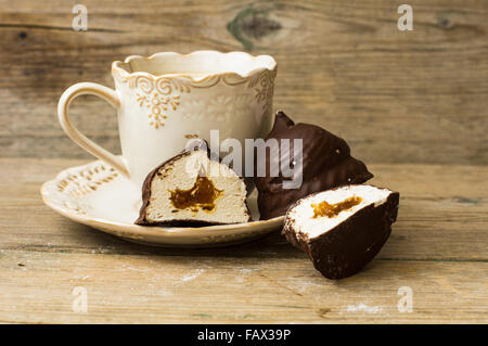 chocolate covered marshmallows or german schokokuss with cup of coffee with milk Stock Photo