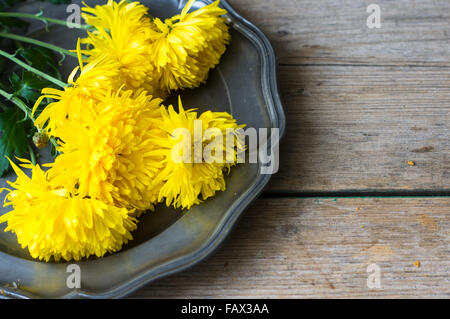 Bright yellow chrysanthemum as a element of autumna table setting on wooden rustic table Stock Photo