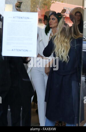 Kylie Jenner sports her green hair with an all white outfit as she visits  the Dash