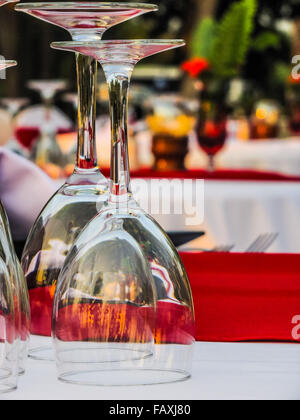 Cocktail glasses for two. Special occasion evening dinner tables set alfresco. Stock Photo