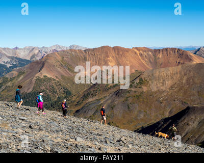 CRESTED BUTTE, COLORADO - SEPTEMBER 20, 2015: Hikers traverse high elevation alpine terrain, Ruby Range, Elk Mountains Stock Photo