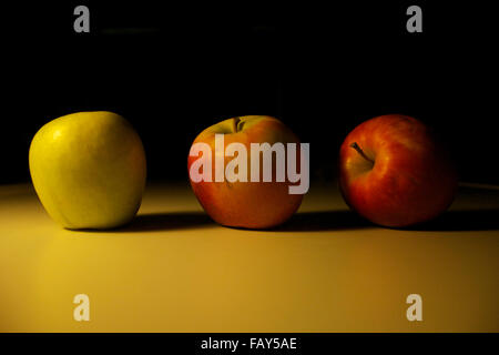 Still life of three different types of apple in a gradient. Stock Photo
