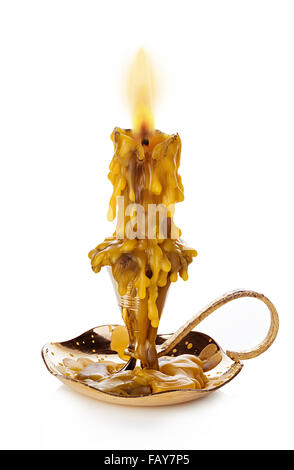 Burning vintage church candle wax  in old gold candlestick isolated on white background. Stock Photo