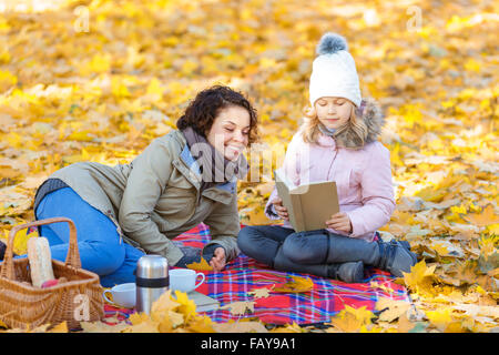 Mother and daughter reading book Stock Photo