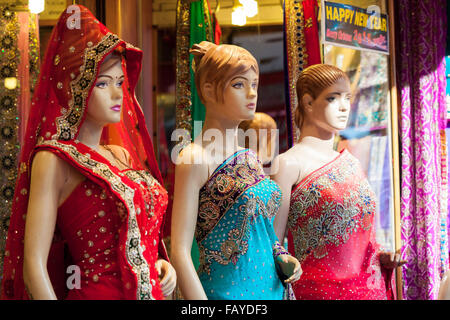 Three mannequins dressed in colourful, embroidered Saris outside a shop in India Stock Photo