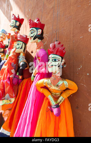 Indian string puppets hanging by a wall. The puppets are used in traditional Rajasthani Theatre called Kathputli. Stock Photo