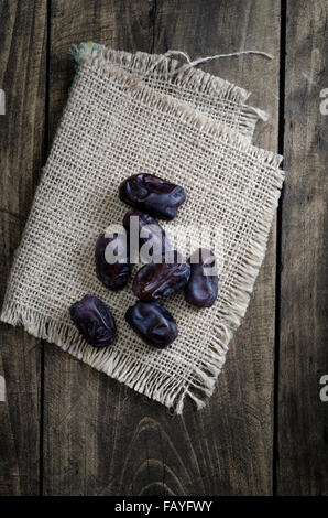 Fresh dried Dates on wooden background, from above Stock Photo